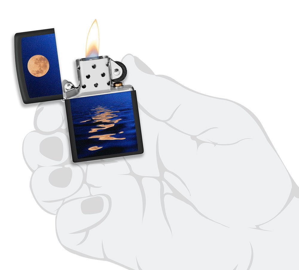 Full Moon Design Black Light Black Matte Windproof Lighter lit in hand.
