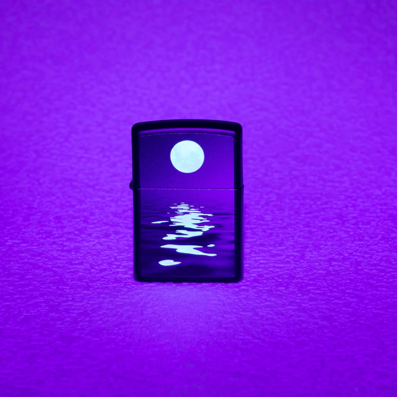 Lifestyle image of Full Moon Design Black Light Black Matte Windproof Lighter showing the blacklight design.