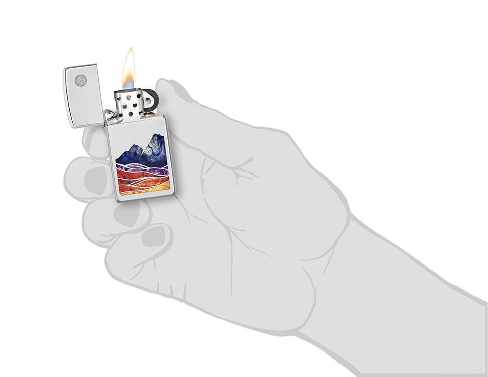 Slim® Landscape Design High Polish Chrome Windproof Lighter lit in hand